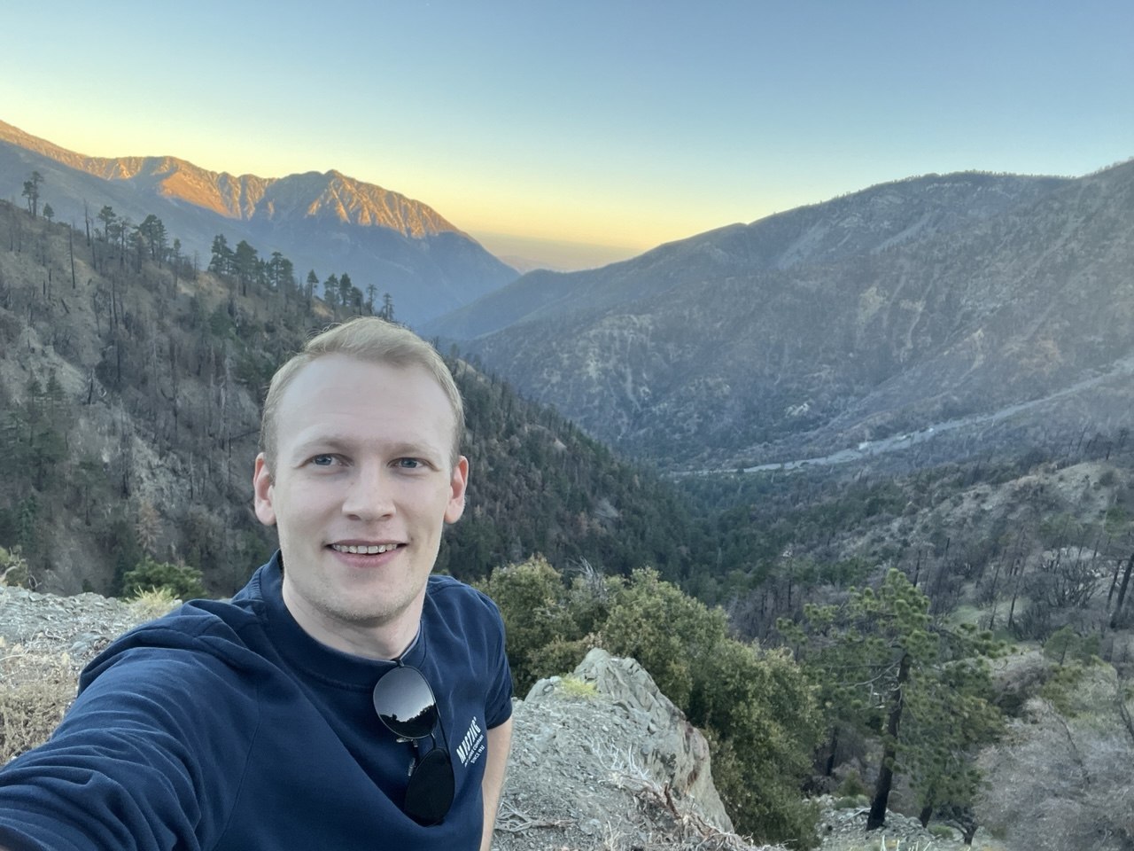 Selfie above a mountain valley at sunset